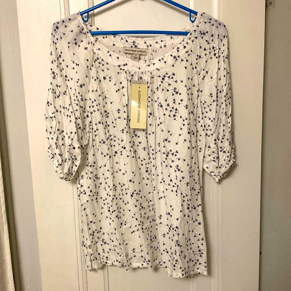 White flowy short-sleeve blouse with black feather print